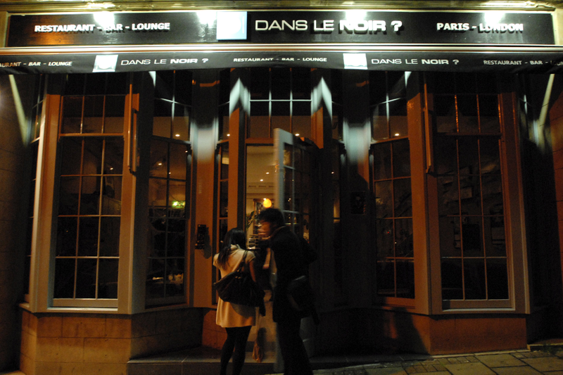 Patrons enter the restaurant Dans Le Noir in London, England, in 2006.